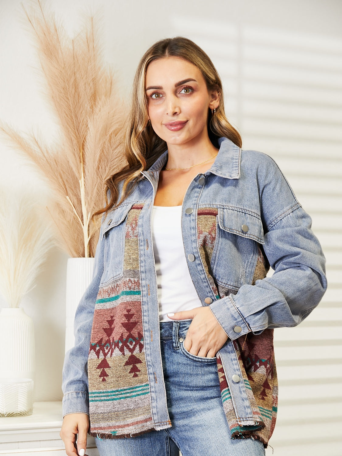 Woman in denim jacket with patterned fabric patches.