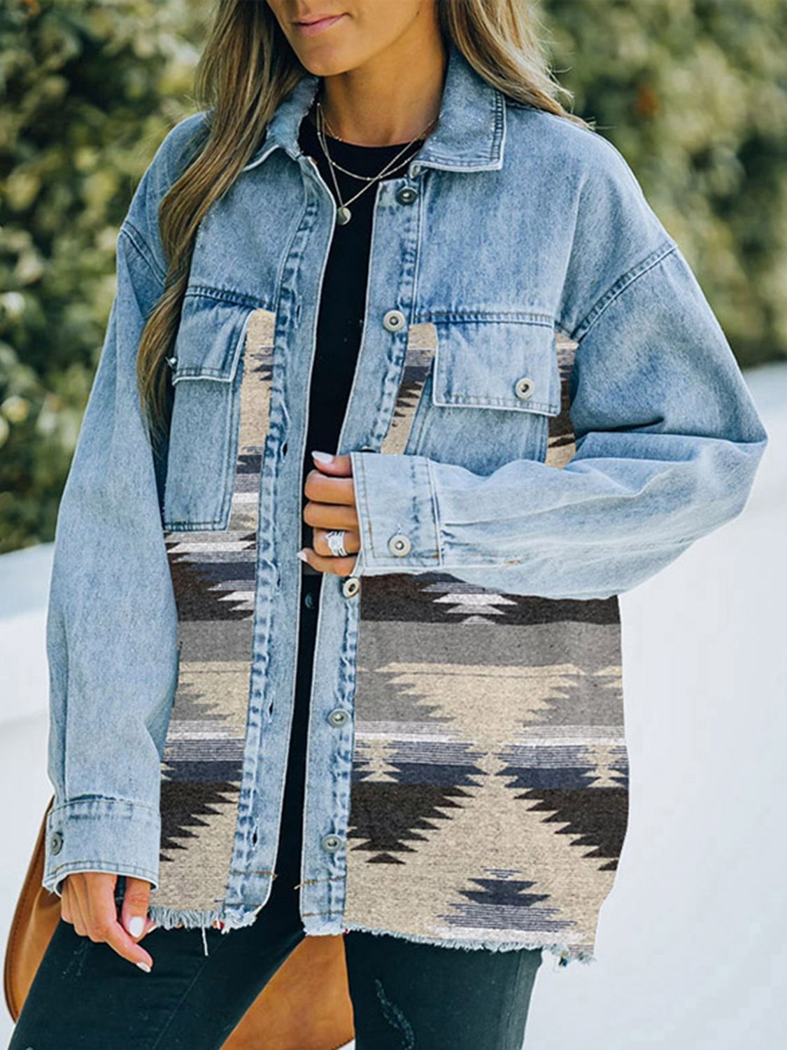 Woman in denim jacket with patterned fabric patches.