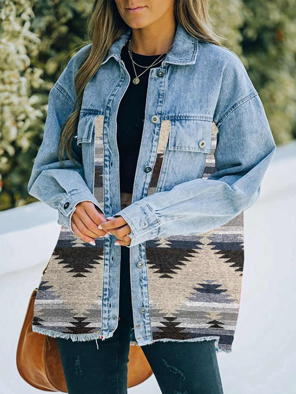 Woman in denim jacket with patterned fabric patches.