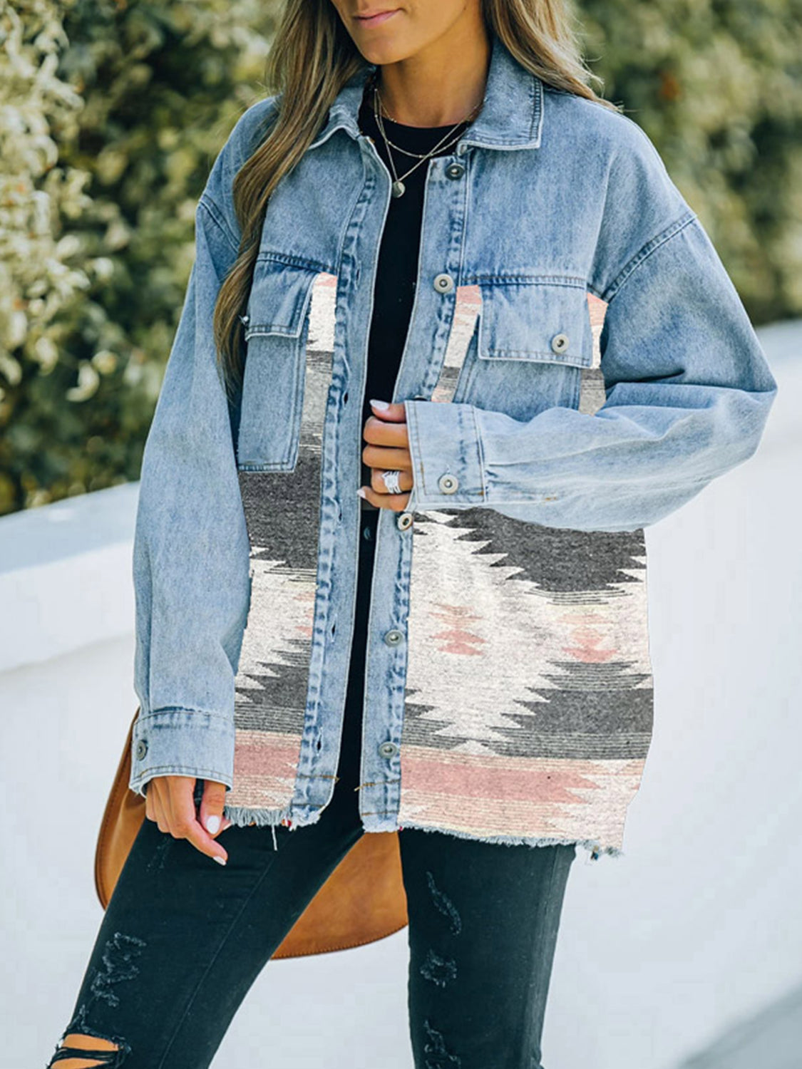 Woman in denim jacket with patterned fabric patches.