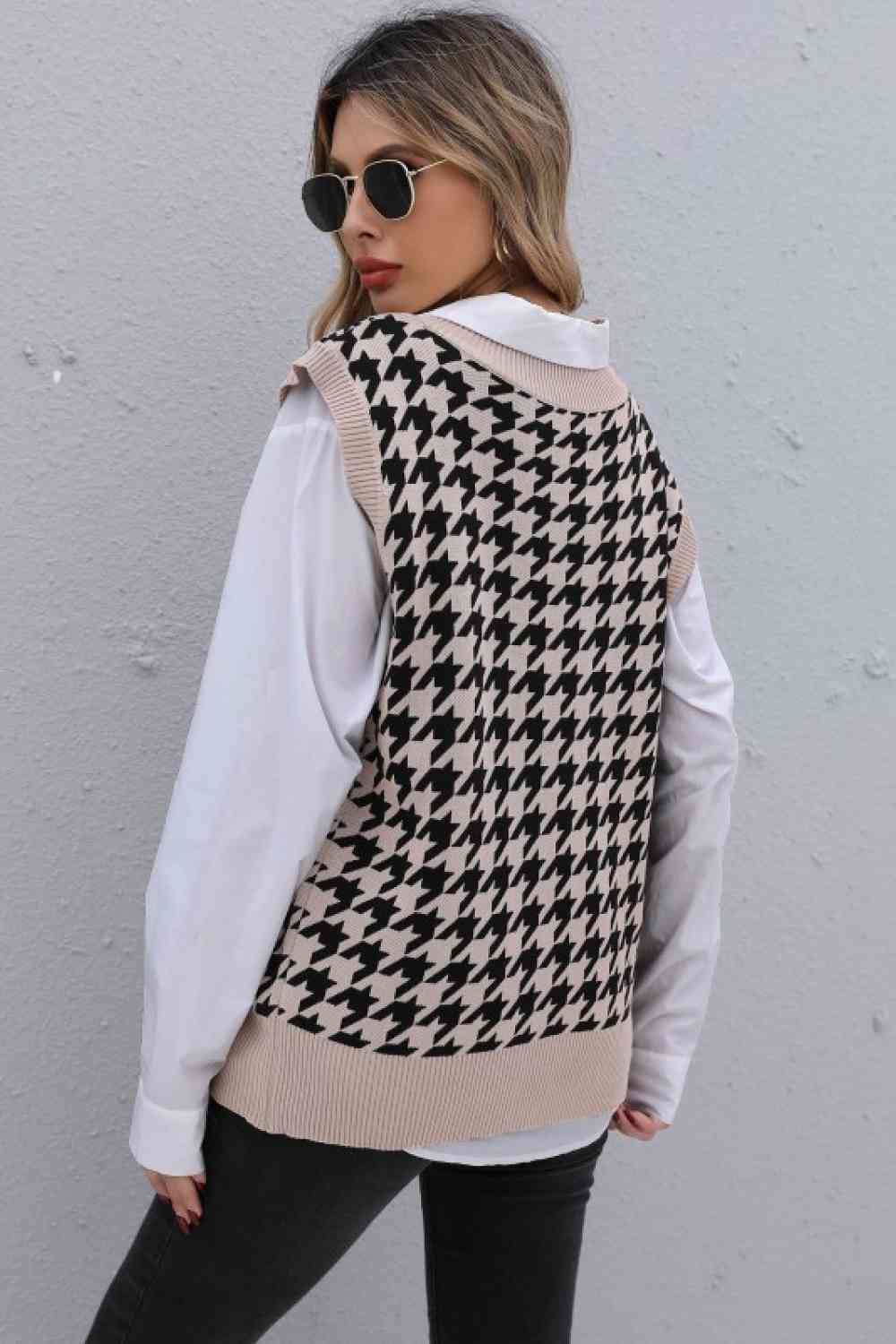 Back view of a woman in a beige houndstooth sweater vest over a white shirt, with black jeans and sunglasses.