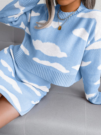 Woman in a blue sweater dress with white cloud patterns