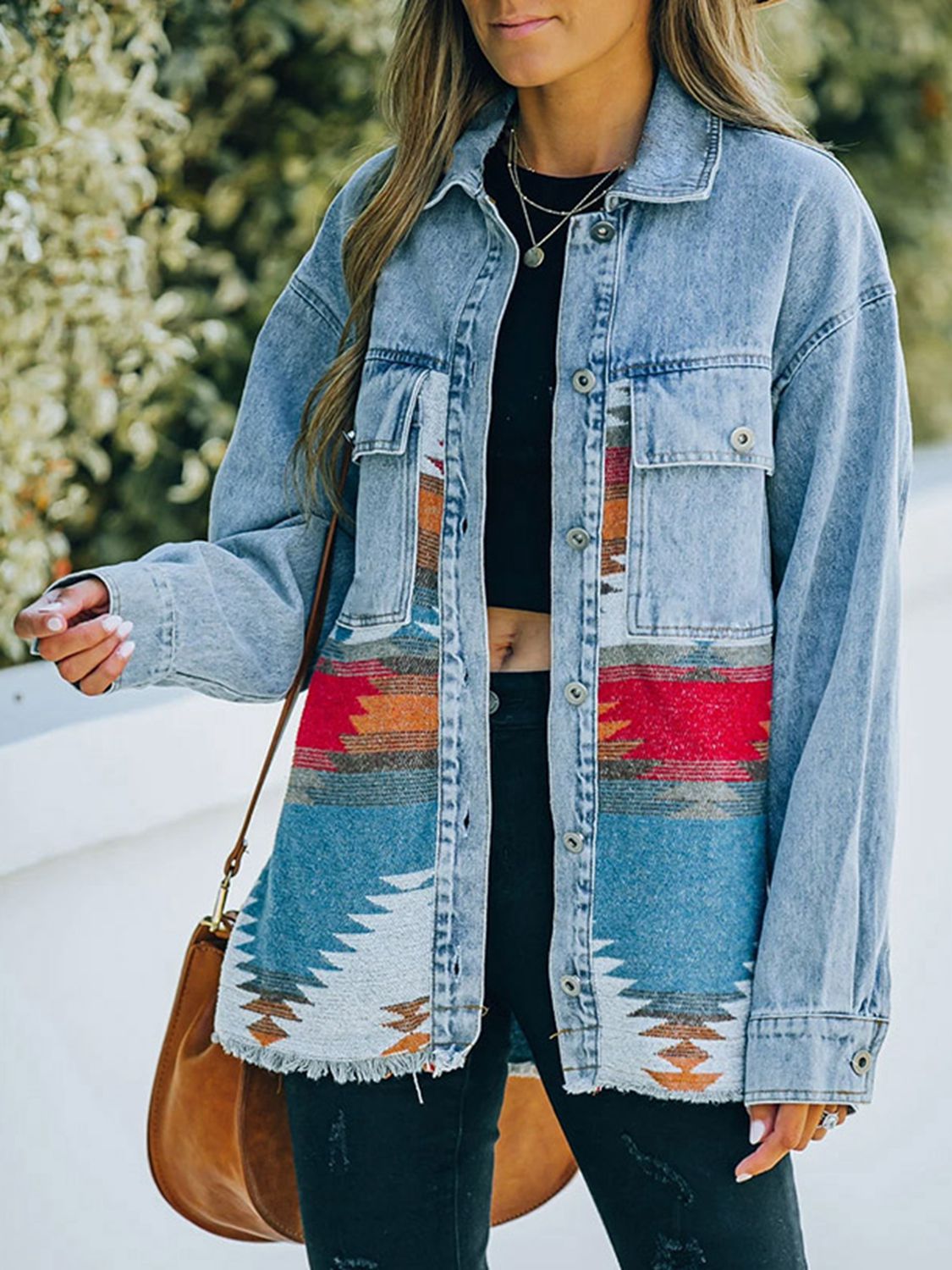  Woman in denim jacket with patterned fabric patches.