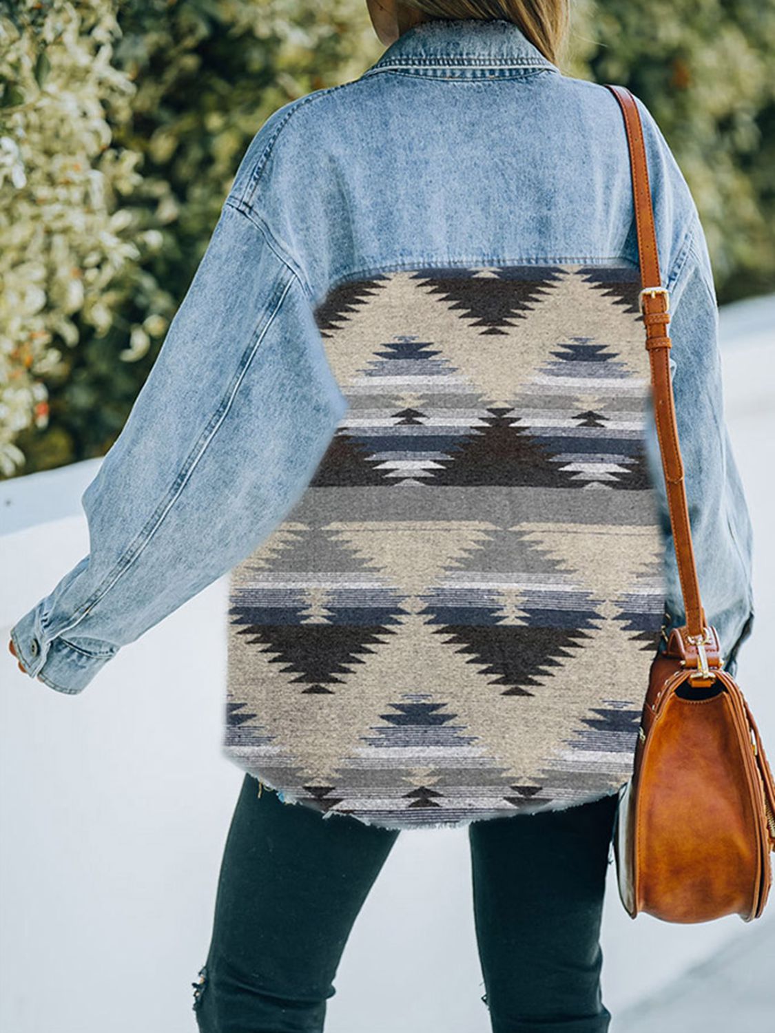  Woman in denim jacket with patterned fabric patches.