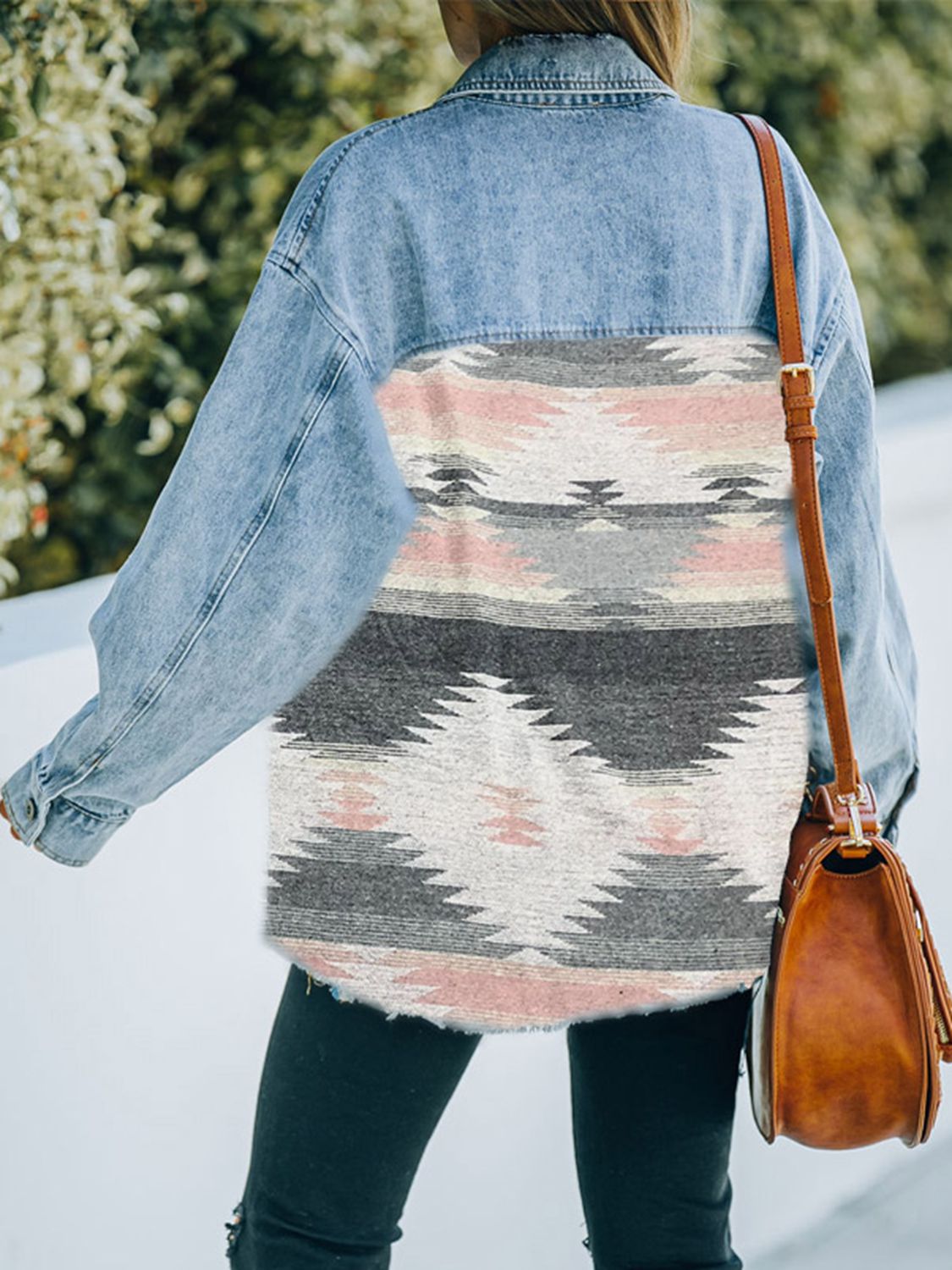  Woman in denim jacket with patterned fabric patches.