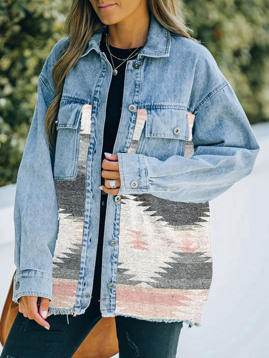  Woman in denim jacket with patterned fabric patches.