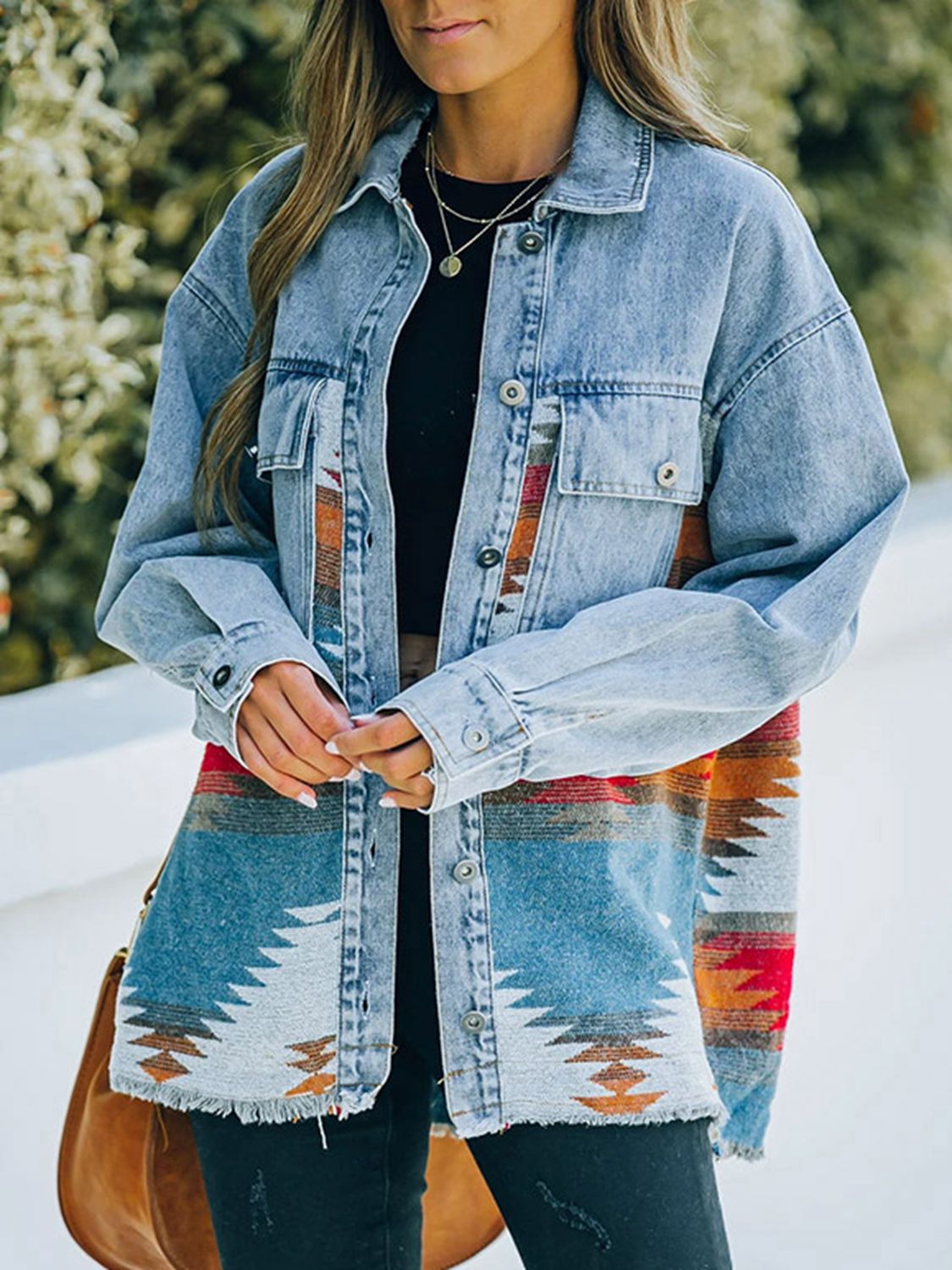  Woman in denim jacket with patterned fabric patches.