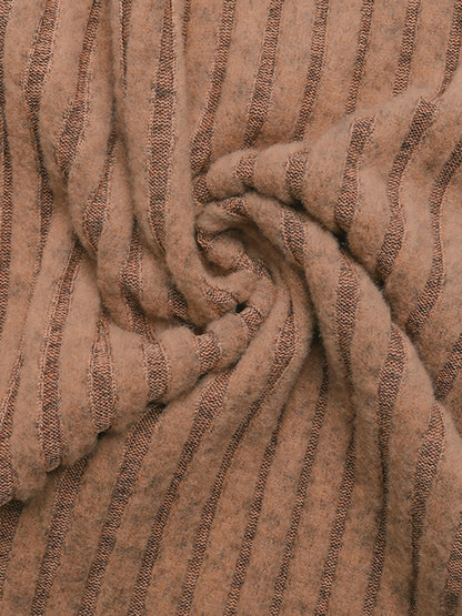 A detailed close-up view of the ribbed knit fabric in a warm camel color, showcasing the soft texture and moderate stretch of the material.