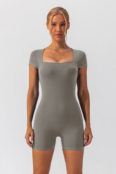 Woman wearing gray shapewear romper