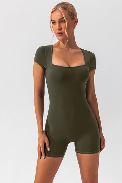 Woman wearing green shapewear romper