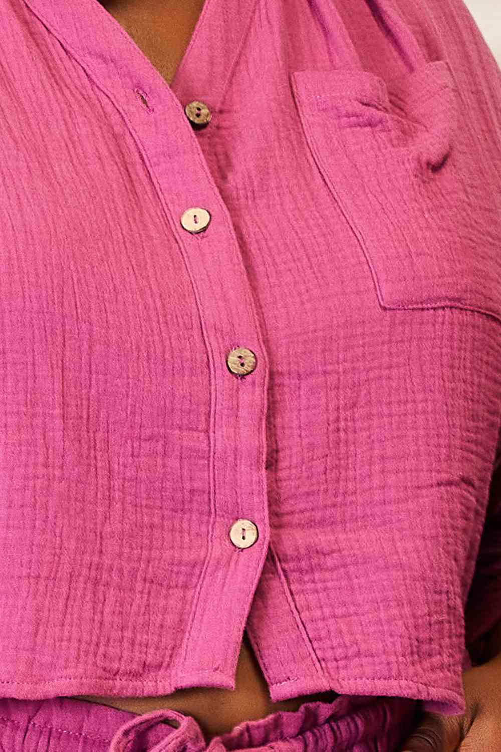 Close up shot of Woman wearing  pink colored top and shorts