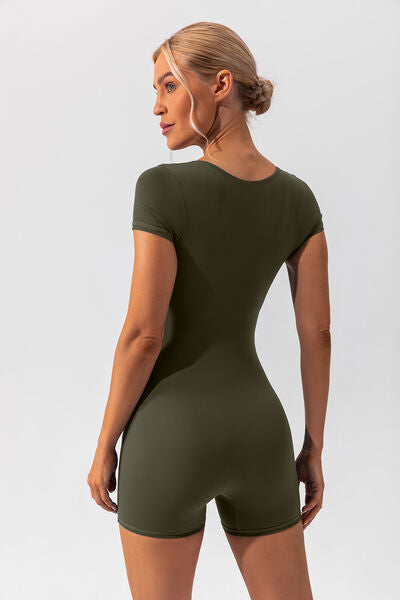 Woman wearing green shapewear romper