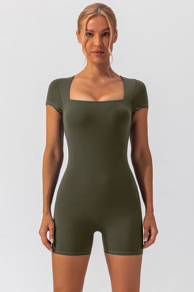 Woman wearing green shapewear romper