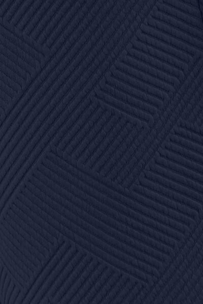 Textured blue fabric with a geometric quilted pattern, displaying a complex array of stitched lines.