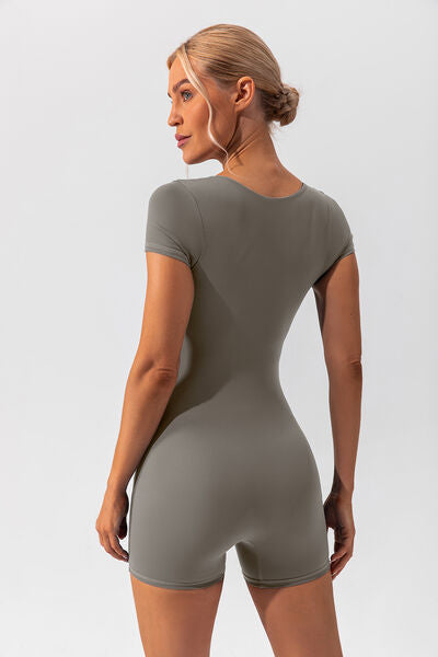 Woman wearing gray shapewear romper